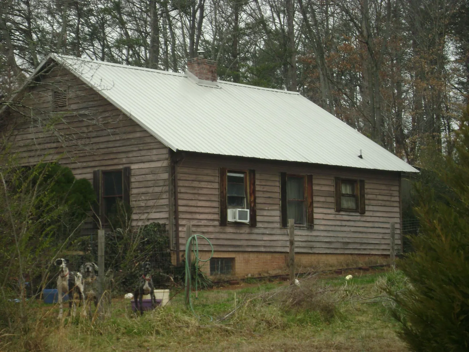 White metal roof on an old wood sided farmhouse, from a Metal Roof Installation job in Laporte